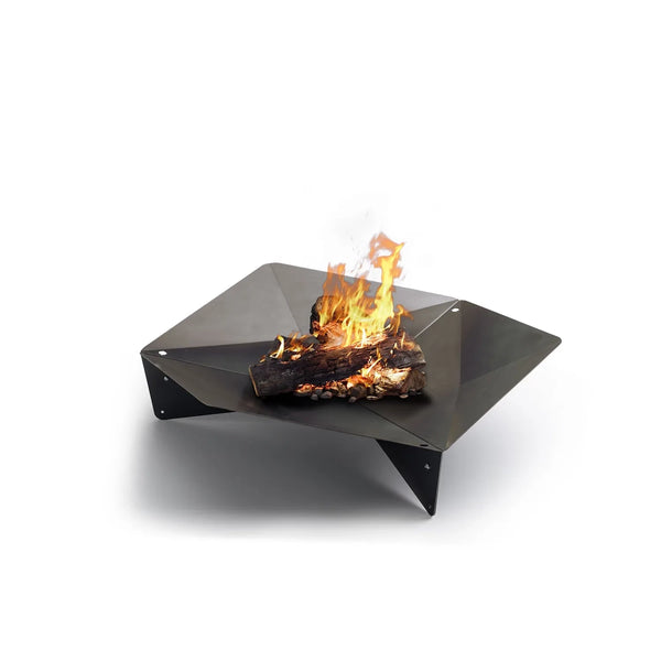 Höfats TRIPLE 120 Fire Pit in Corten Steel with burning logs, placed on a white surface.